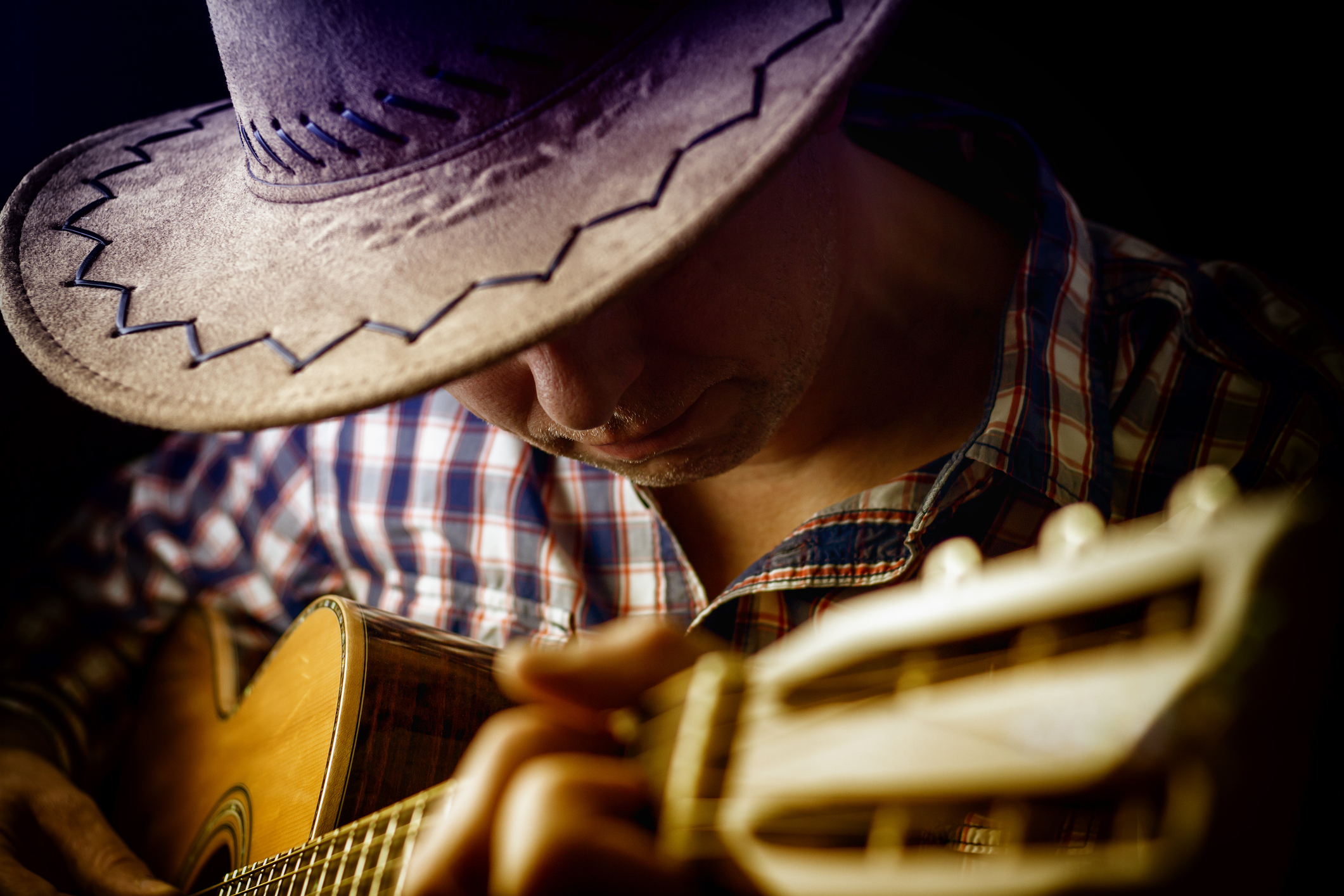 country artist playing the guitar