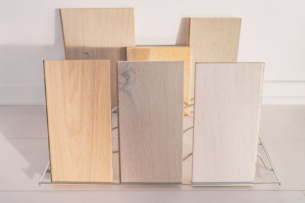 A wire frame propping engineered wood samples for display 