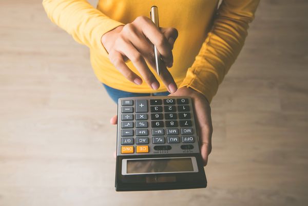 A close-up of a person using a calculator 