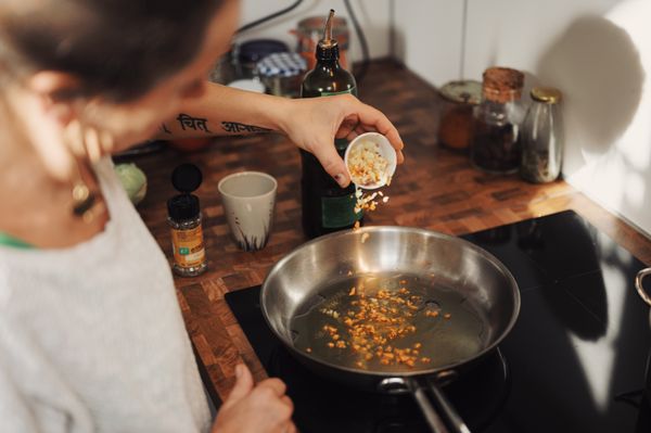 Woman using Miele Induction Cooktop