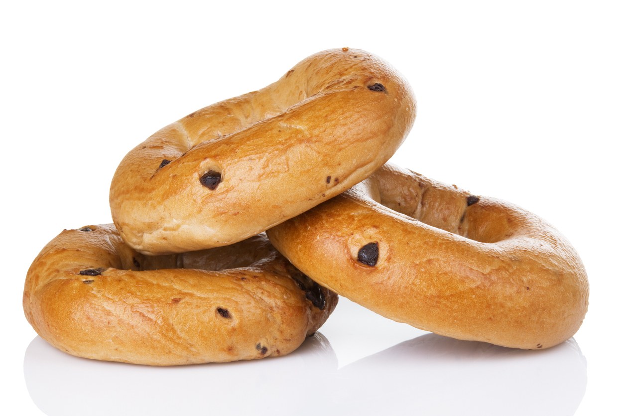 three chocolate chip bagels on a white background