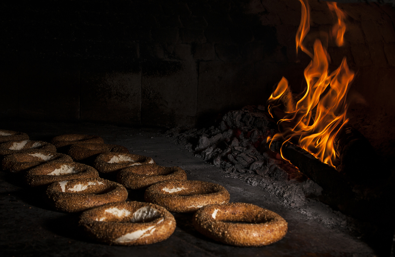 two rows of Montreal bagels in a wood oven