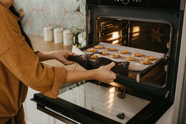 woman pulling cookies out of her convection oven