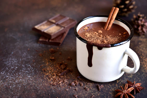 a coffee mug with a cinnamon stick and chocolate bar