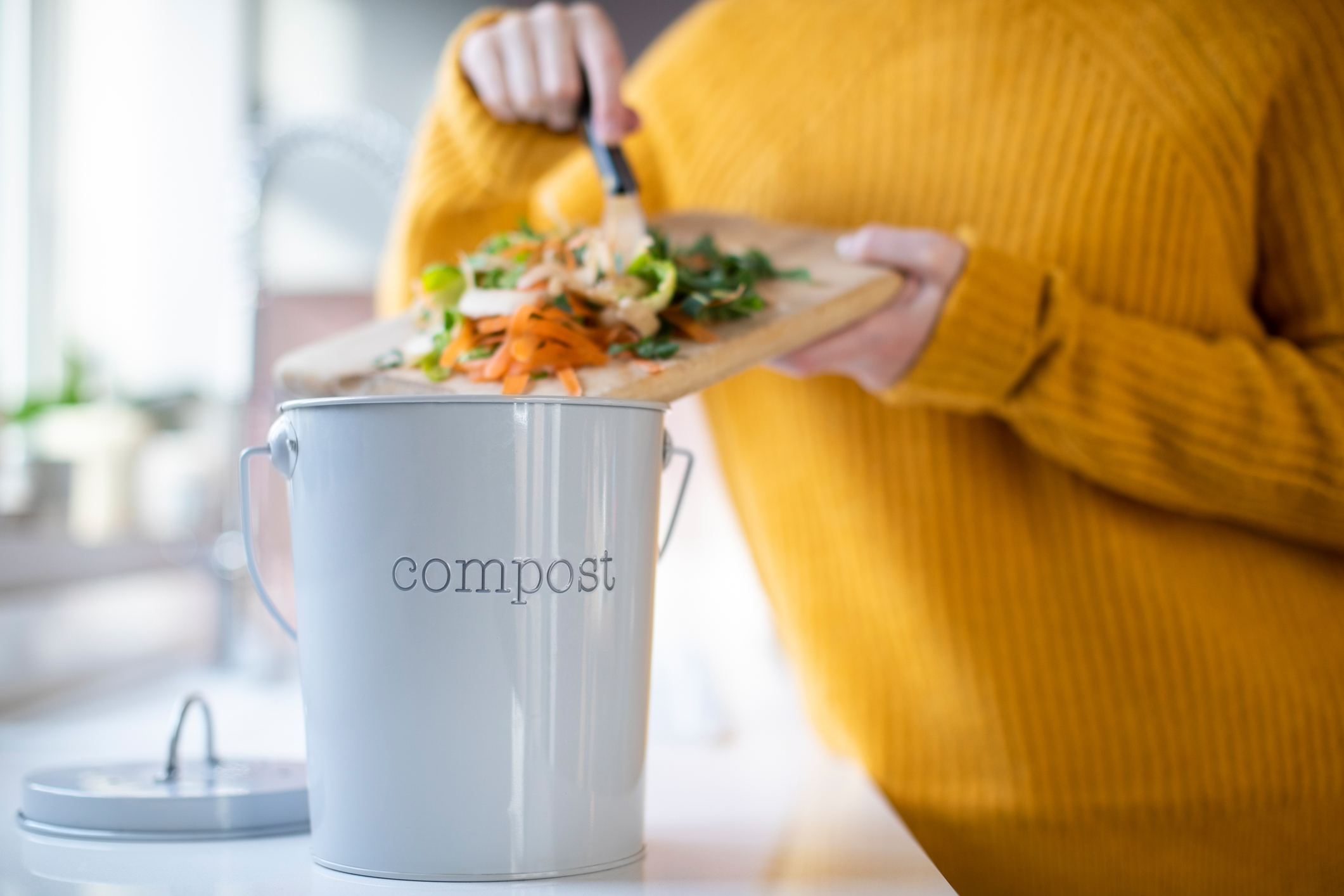 disposing of food waste into compost bin
