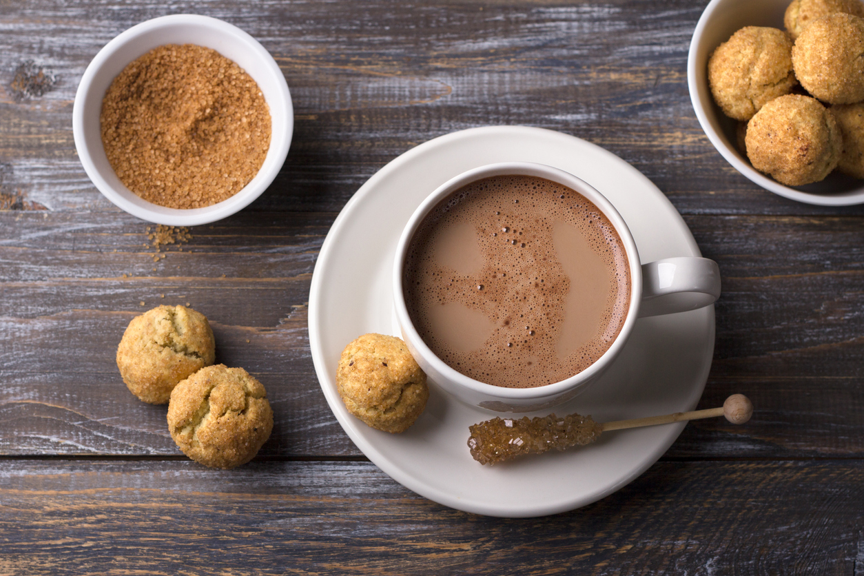 snickerdoodle cookies with cinnamon and nuts, hot chocolate on wooden background