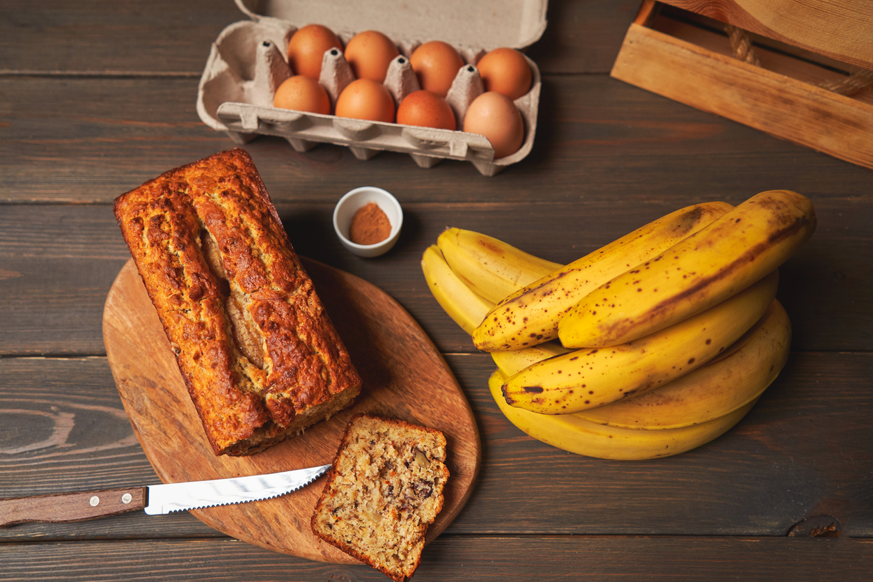 baked banana bread surrounded by healthy ingredients