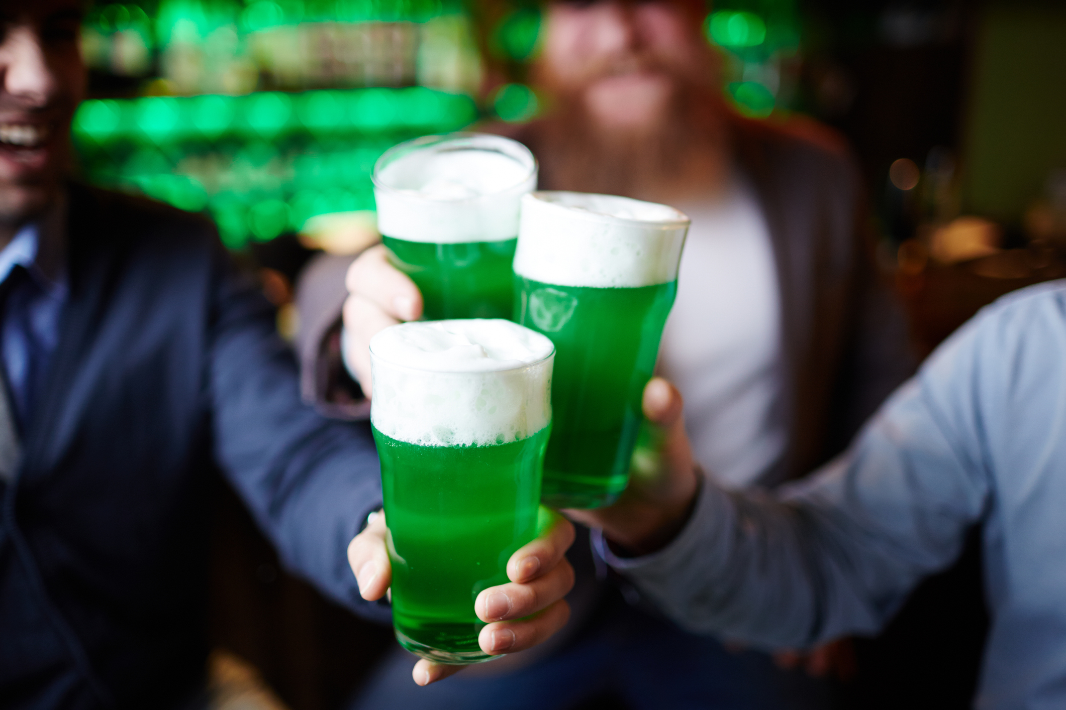 cheersing a pint of green beer