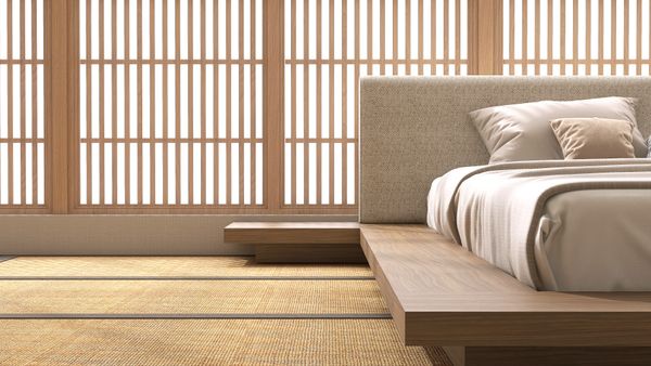 A minimalist bedroom featuring a platform bed 