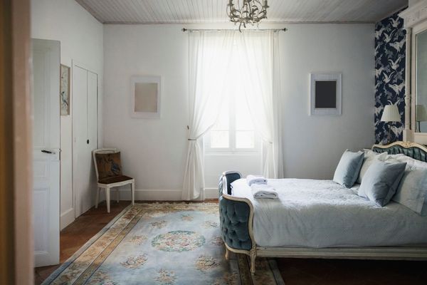 wide shot of a bedroom with French provincial details 
