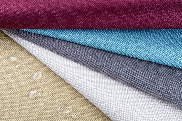 Close view of performance fabrics with droplets of water on them.