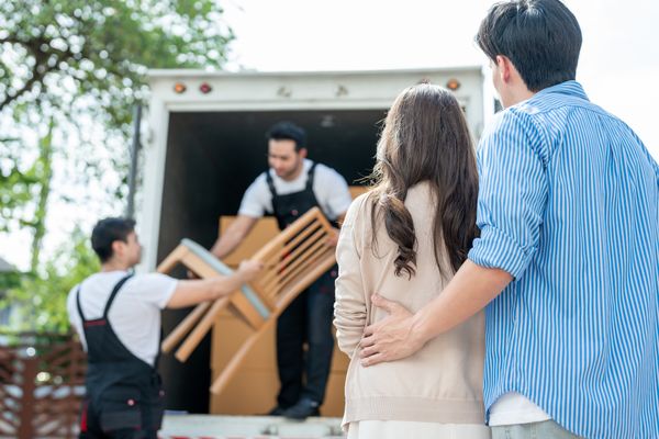 A couple watching furniture delivers ship chairs