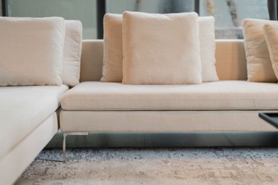 A close-up of a modern cream sectional sofa 