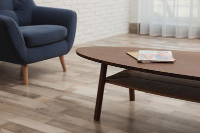 A dark wood coffee table with magazines