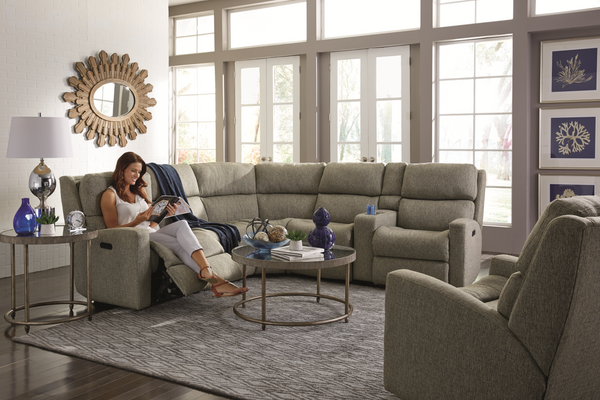 A woman smiling and sitting on a Flexsteel sectional 