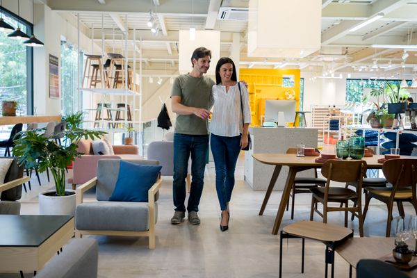 Partners walking through a furniture store 