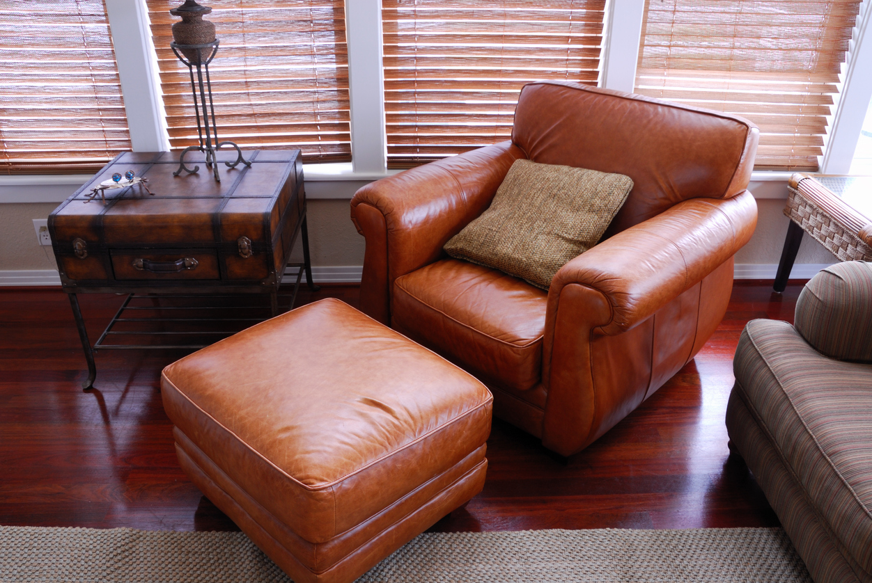 leather armchair with an ottoman and industrial style table