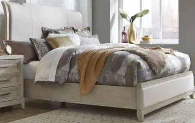 The Liberty Furniture Belmar collection upholstered bed with bedding and decor