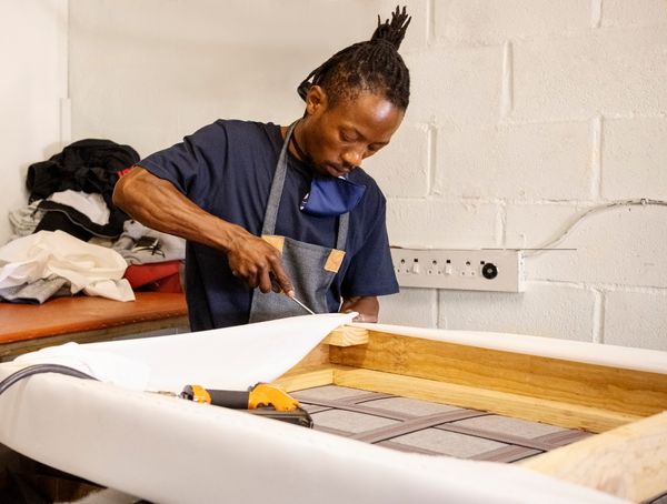A man crafting a sofa