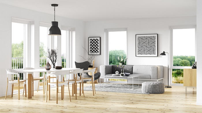 Modern living room with light colored furniture on a hardwood floor.