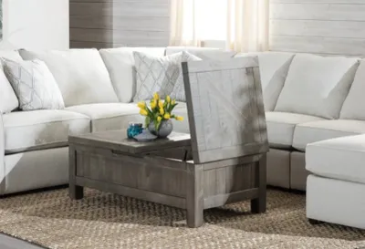 The Modus Furniture Taryn coffee table shown with its top lifted 