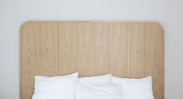 A close-up of an oak headboard