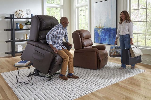 view of a man standing getting out of a lift recliner talking to a woman holding shopping bags
