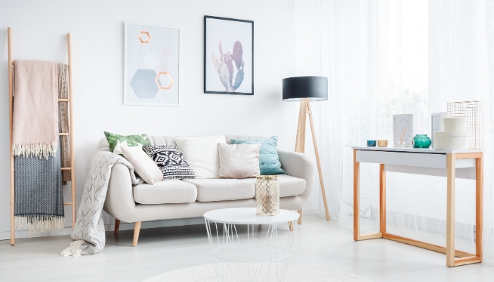 A stylish living room with blankets hanging on a ladder