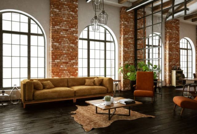 modern industrial living room with large arched windows, brick walls, and modern industrial furniture throughout