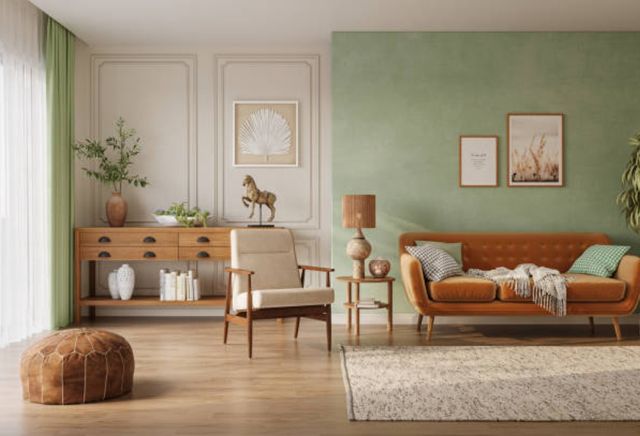 front view of a trendy modern living room with brown/orange furniture and light green walls