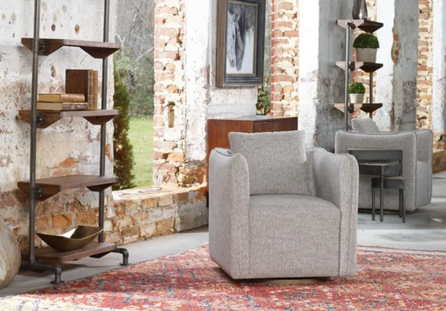 view of a rustic living room corner with brick walls and a grey accent chair
