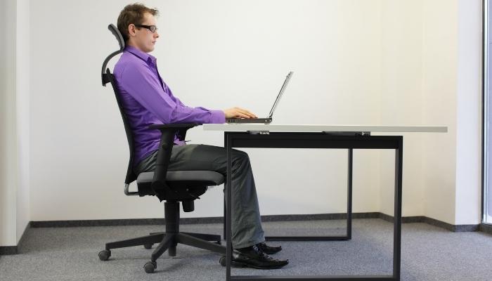 Man sitting in office chair with good posture