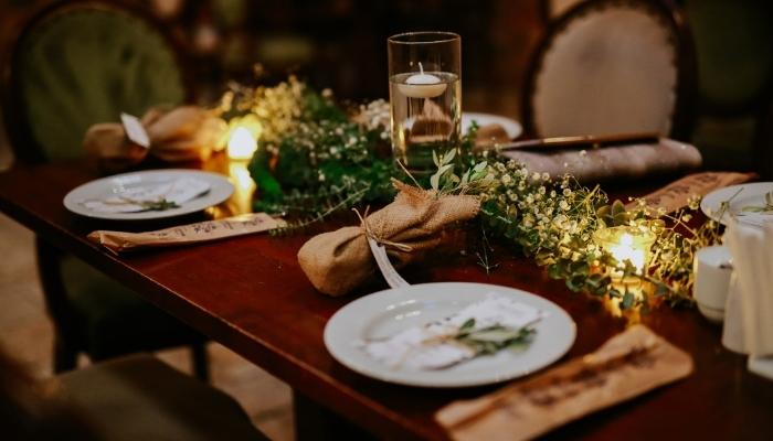 Dining table with settings and plant