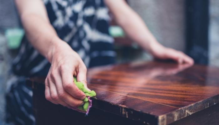 Person refinishing wood furniture