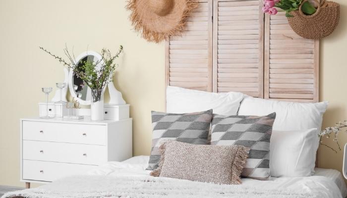 Bed with lighter-colored throw and furniture