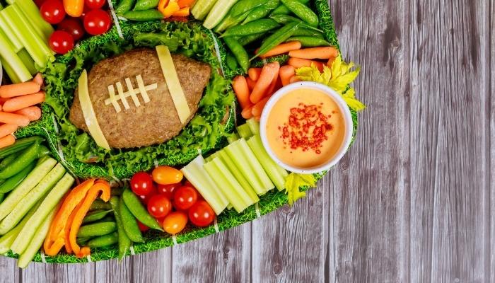 Tray with football loaf and healthy snacks