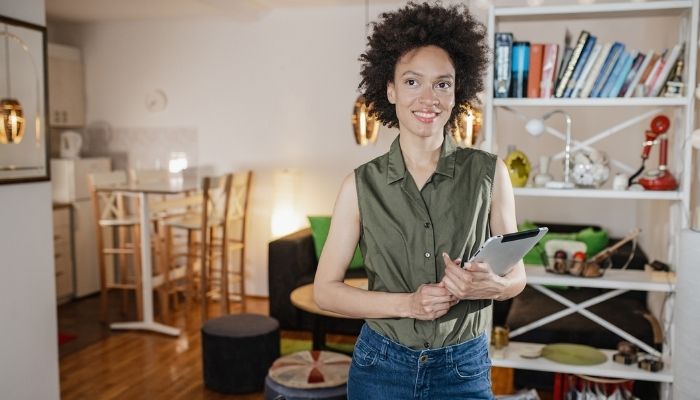 woman smiling in front of bookcase