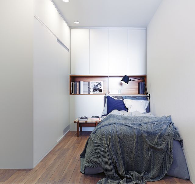 small grey bed with books behind it