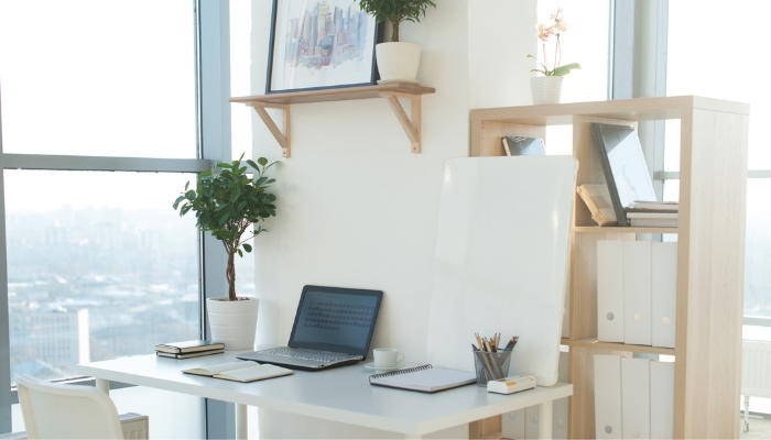 Desk with computer in the center and essentials to the right