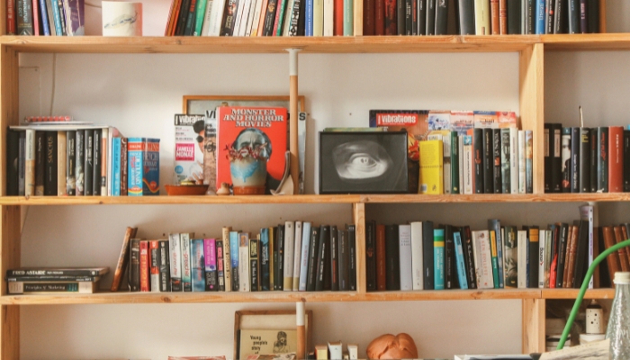 Organized bookshelf with lots of homey touches