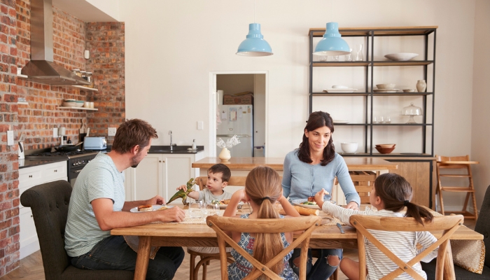 Family eating at a dining table with mixed chairs