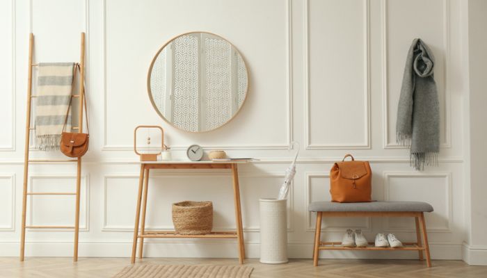 Home entry way with a short bench, mirror, and table