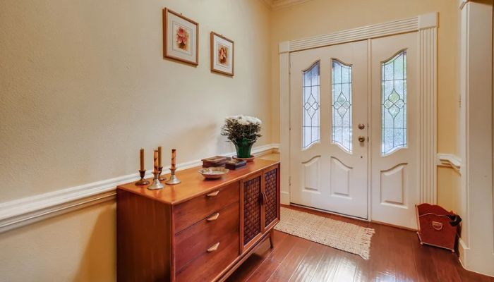 Vintage entryway table with candle sticks in a warmly light home