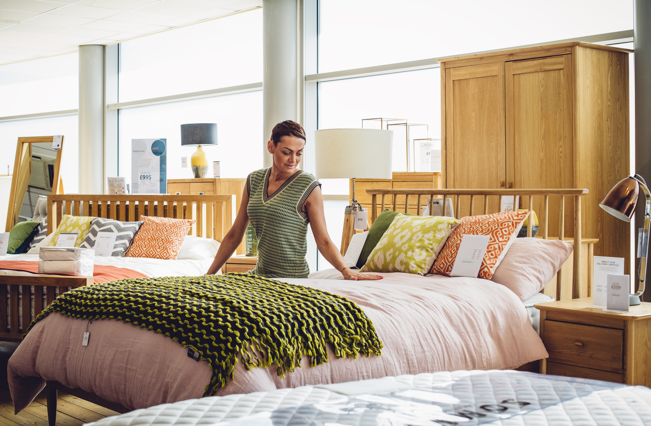 woman shopping for bed at store