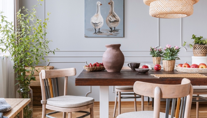 A dining room with a wooden table and natural material accents throughout.
