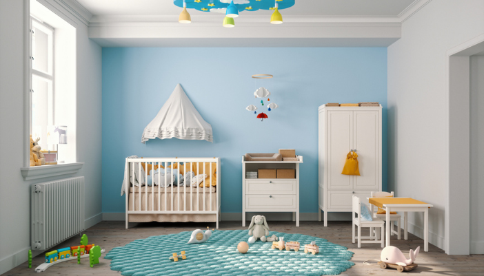 A baby nursery with blue walls and cloud-like, dreamy accents.