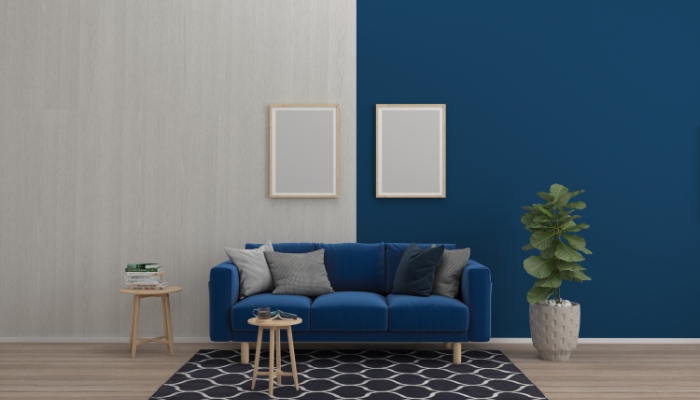 Navy sofa against a neutral and navy wall