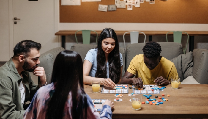 Group of friends playing board games in living room