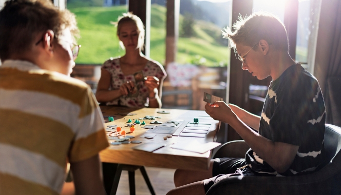 Family playing board games in comfy chair