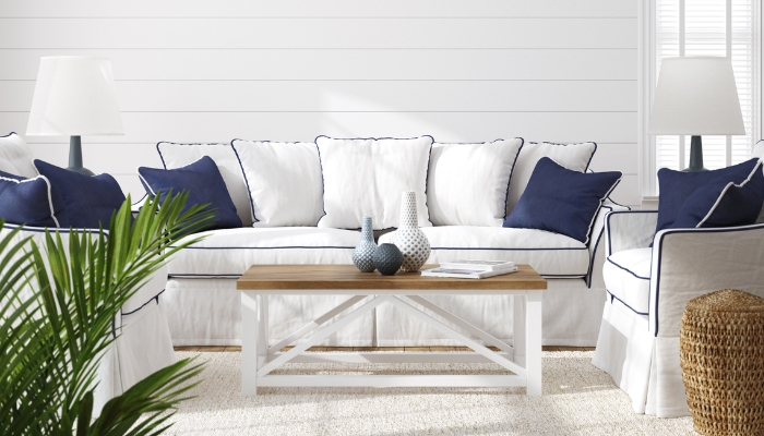 Linen-colored sofa with navy blue throw pillows